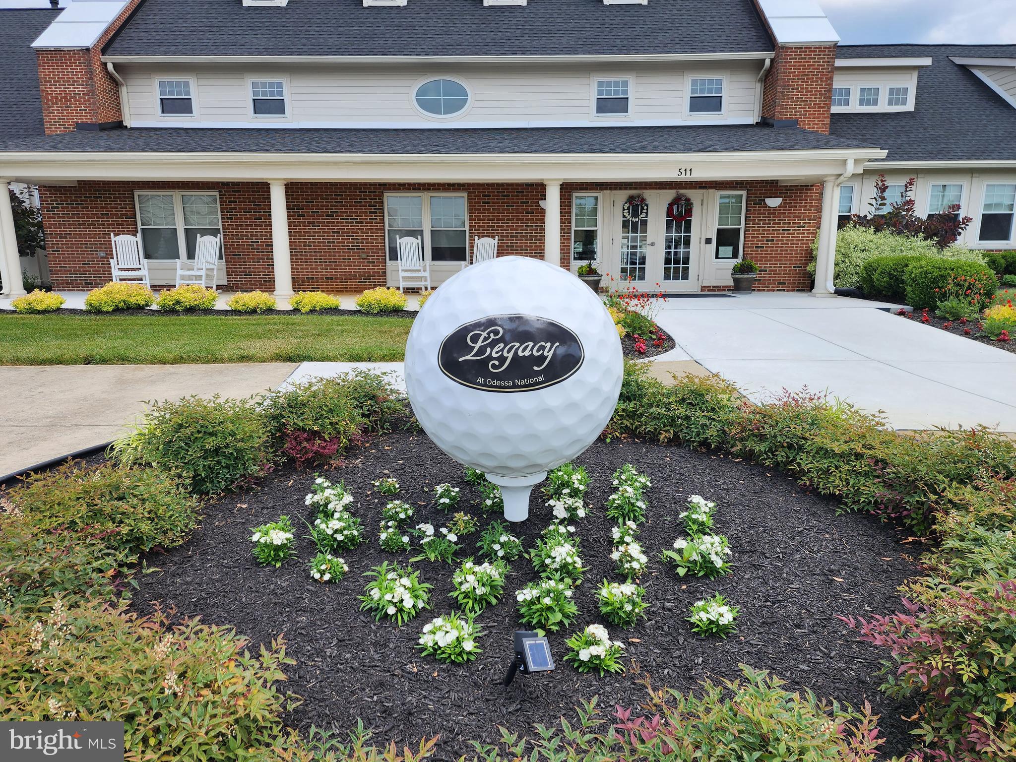 546 Stonehaven Drive Townsend, DE 19734 - Photo 54 of 60 a front view of a brick house with a yard