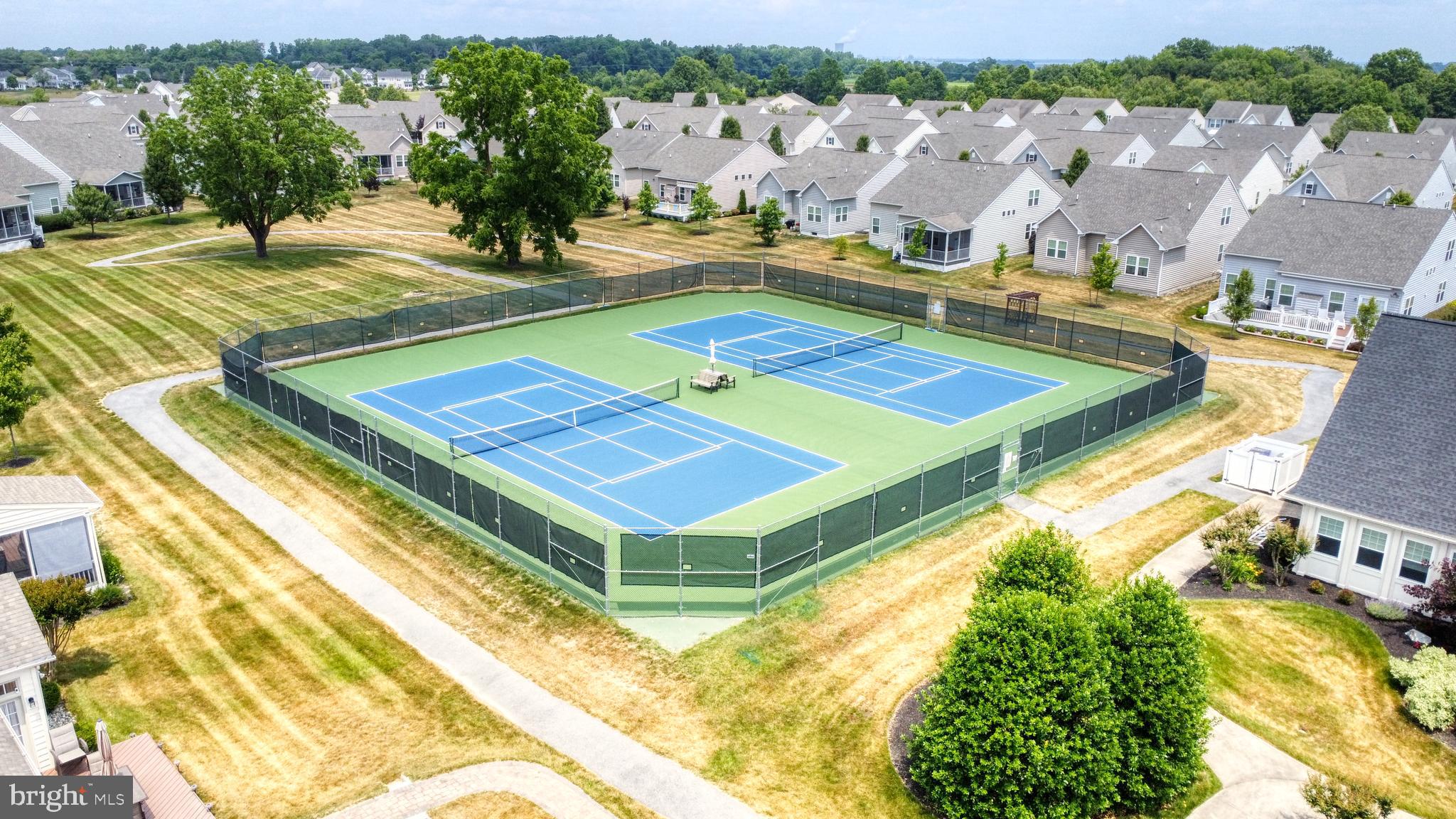 546 Stonehaven Drive Townsend, DE 19734 - Photo 56 of 60 a view of a tennis ground with large trees