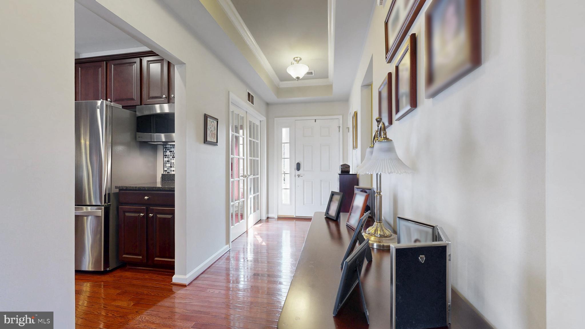 546 Stonehaven Drive Townsend, DE 19734 - Photo 8 of 60 a view of a hallway with wooden floor and staircase