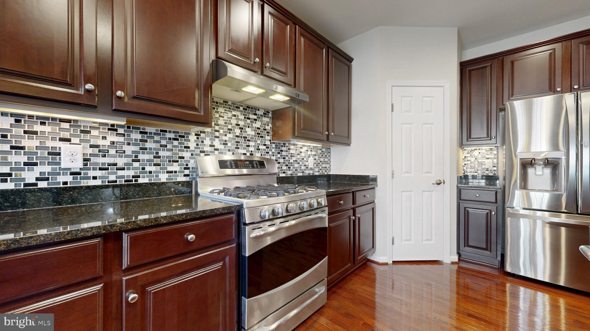 546 Stonehaven Drive Townsend, DE 19734 - Photo 9 of 60 a kitchen with granite countertop stainless steel appliances and wooden cabinets