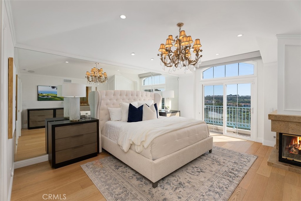 74 Chandon Newport Coast, CA 92657 - Photo 12 of 27 a bedroom with a bed and a fireplace