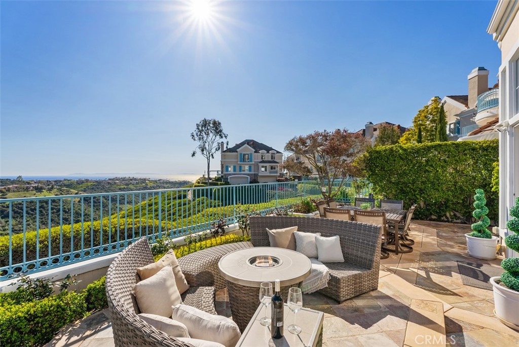 74 Chandon Newport Coast, CA 92657 - Photo 20 of 27 a view of a chairs and table in patio with a lake view