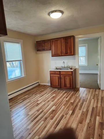 a view of a room with wooden floor and cabinet