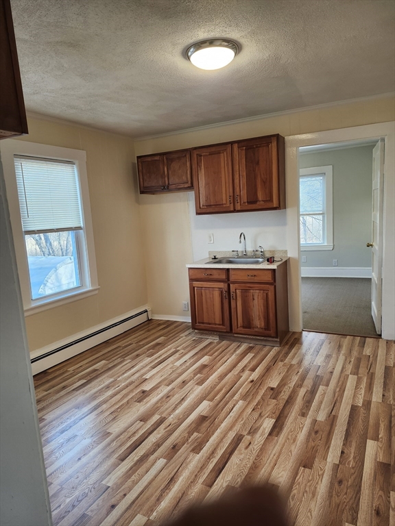 68 Valley Street, Unit 1 Wakefield, MA 01880 - Photo 2 of 7 a view of a room with wooden floor and cabinet