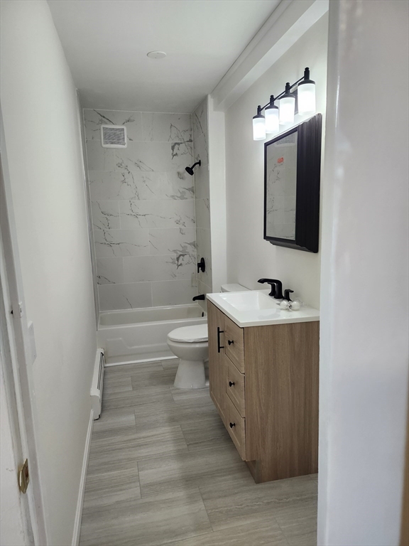 68 Valley Street, Unit 1 Wakefield, MA 01880 - Photo 7 of 7 a bathroom with a double vanity sink mirror and toilet