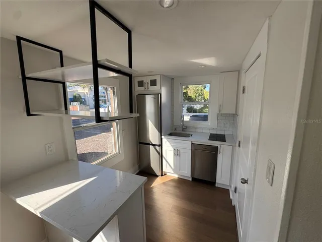 a kitchen with a refrigerator and a sink