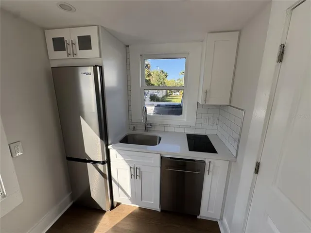 a kitchen with stainless steel appliances a refrigerator and a stove