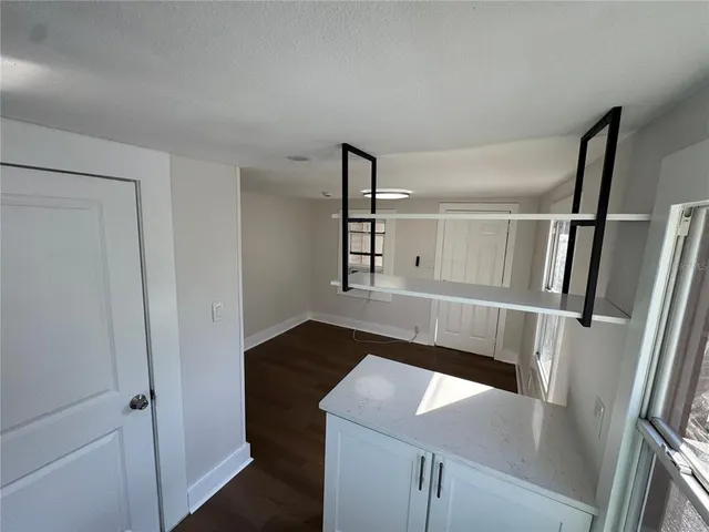 a hallway with table and white cabinet