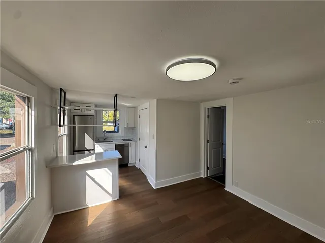 a view of a living room with hardwood floor and a window