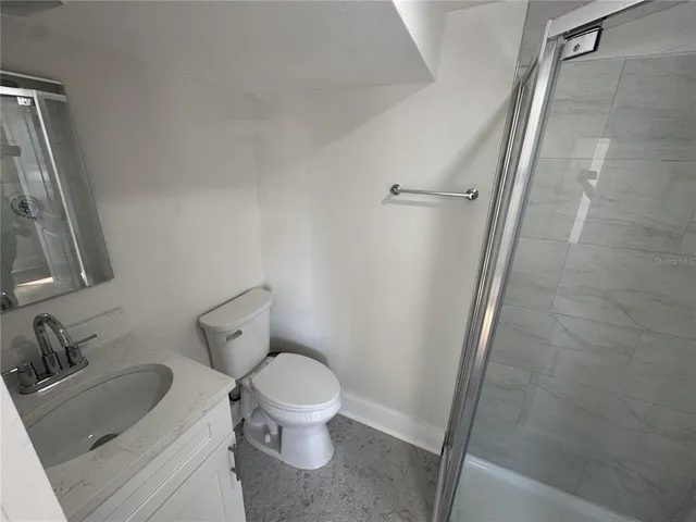 a white toilet sitting next to a bathroom sink