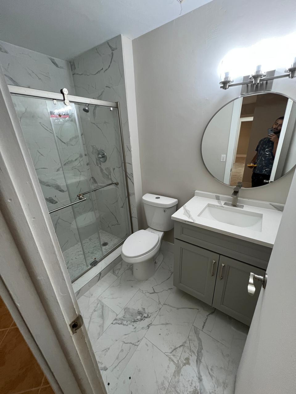 9675 Southwest 1st Place Boca Raton, FL 33428 - Photo 2 of 11 a bathroom with a sink toilet and shower