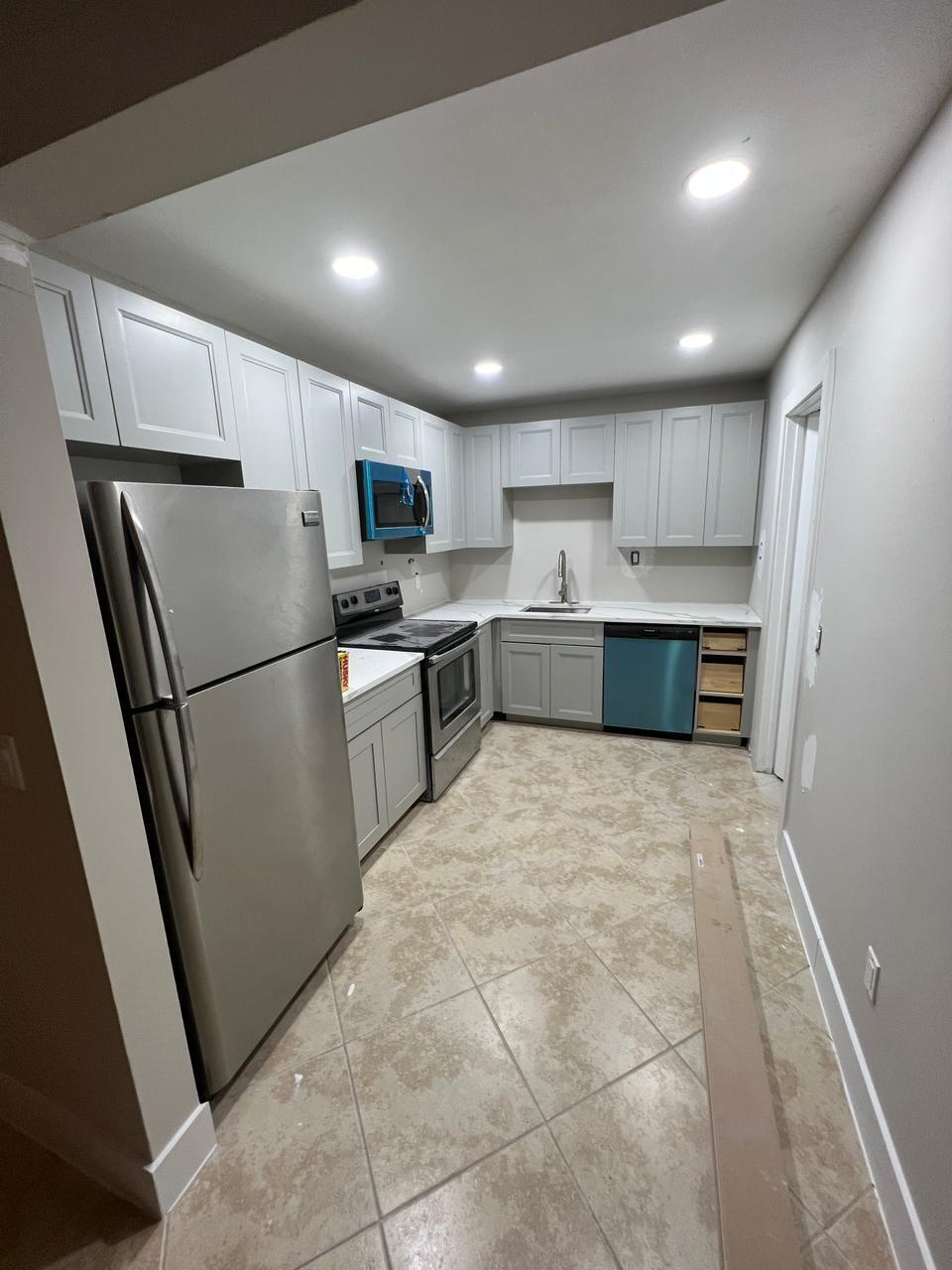9675 Southwest 1st Place Boca Raton, FL 33428 - Photo 4 of 11 a large kitchen with a refrigerator and a sink
