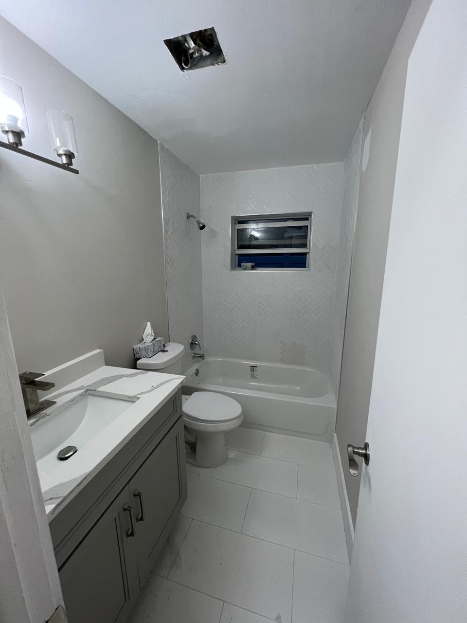 9675 Southwest 1st Place Boca Raton, FL 33428 - Photo 5 of 11 a bathroom with a granite countertop sink toilet and shower