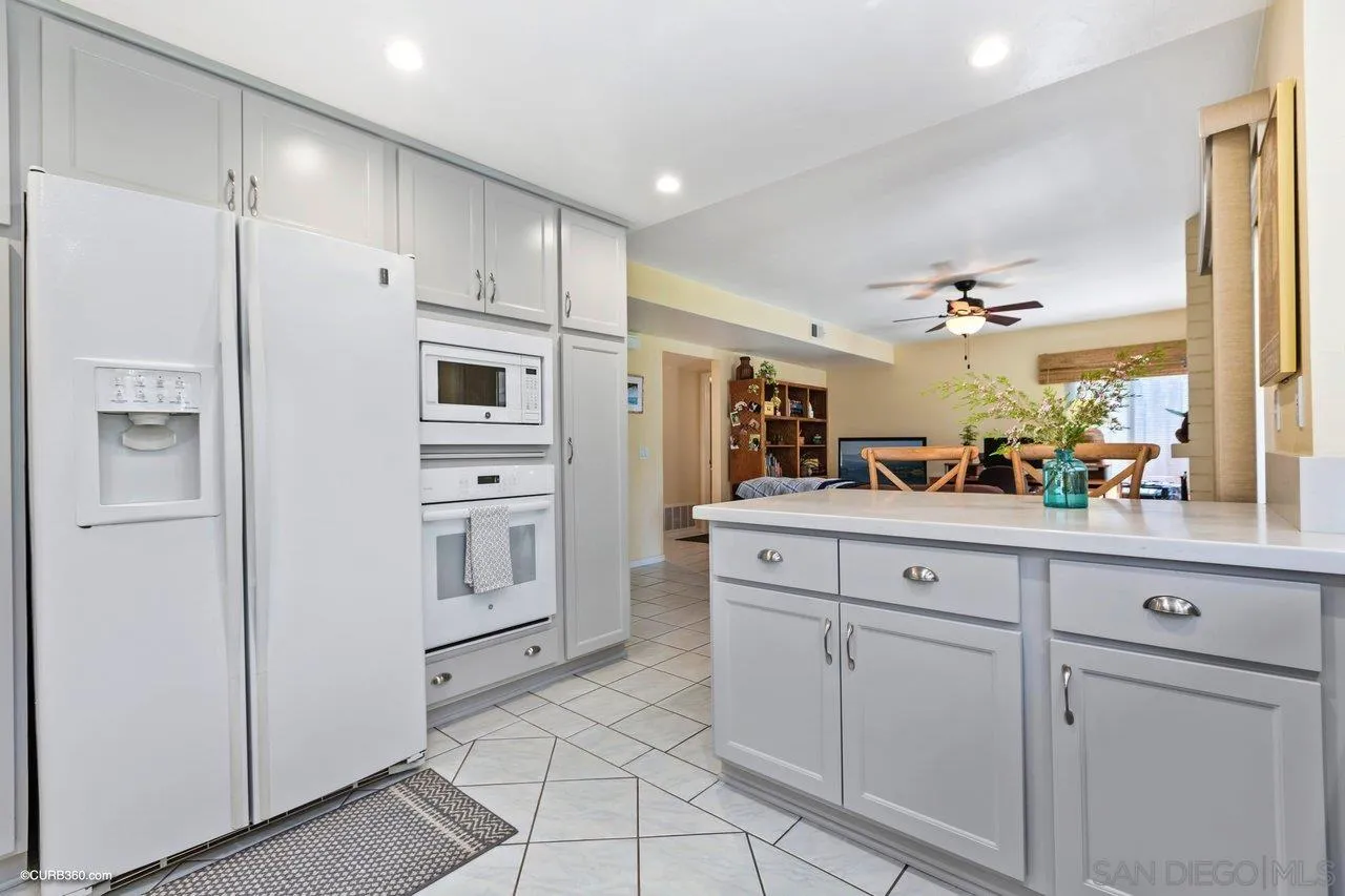744 Roca Road Chula Vista, CA 91910 - Photo 11 of 24 a kitchen with white cabinets and white appliances