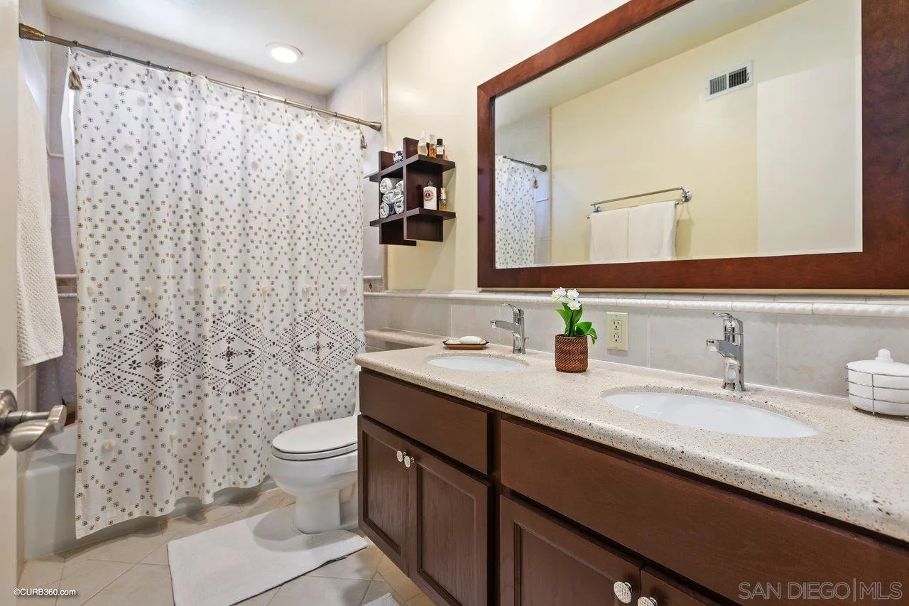 744 Roca Road Chula Vista, CA 91910 - Photo 19 of 24 a bathroom with a sink toilet and shower