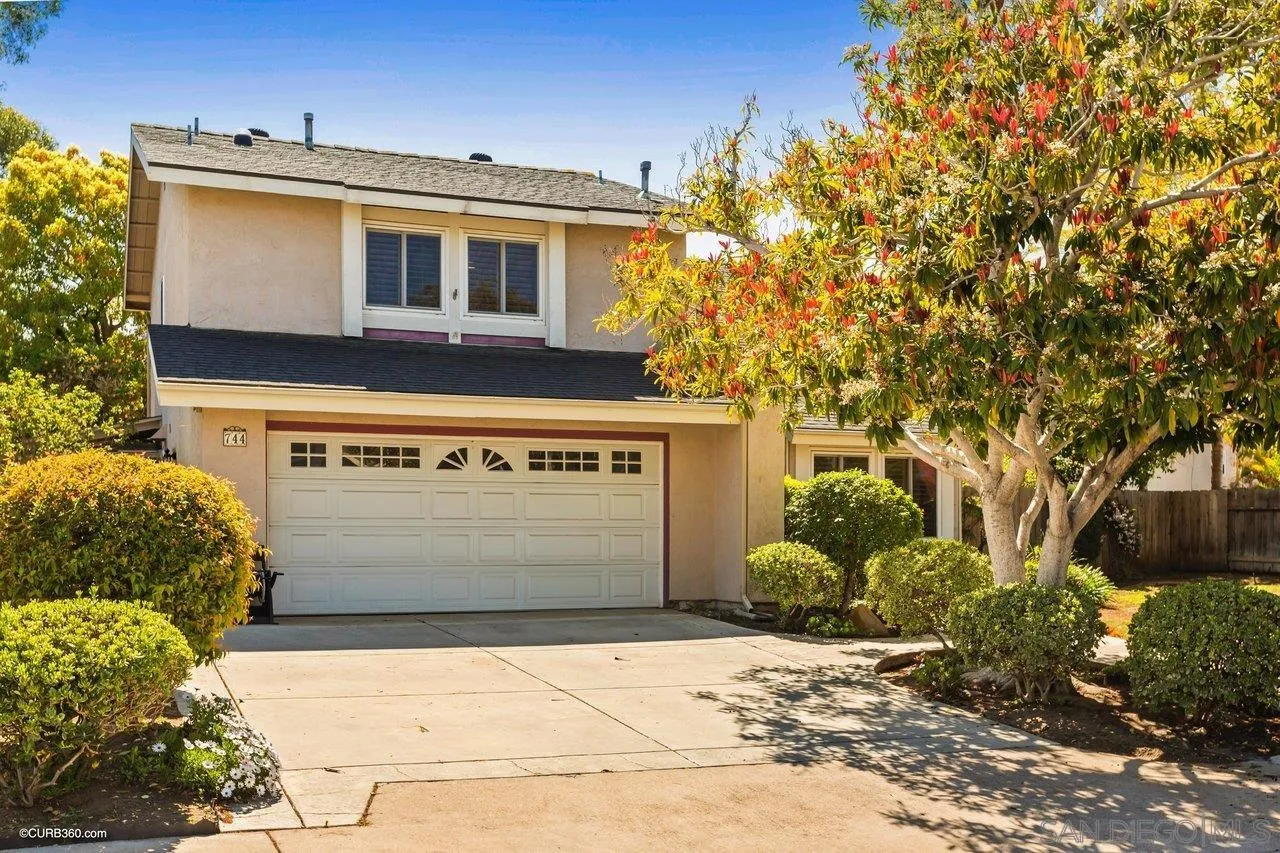 744 Roca Road Chula Vista, CA 91910 - Photo 20 of 24 a front view of a house with a yard and garage