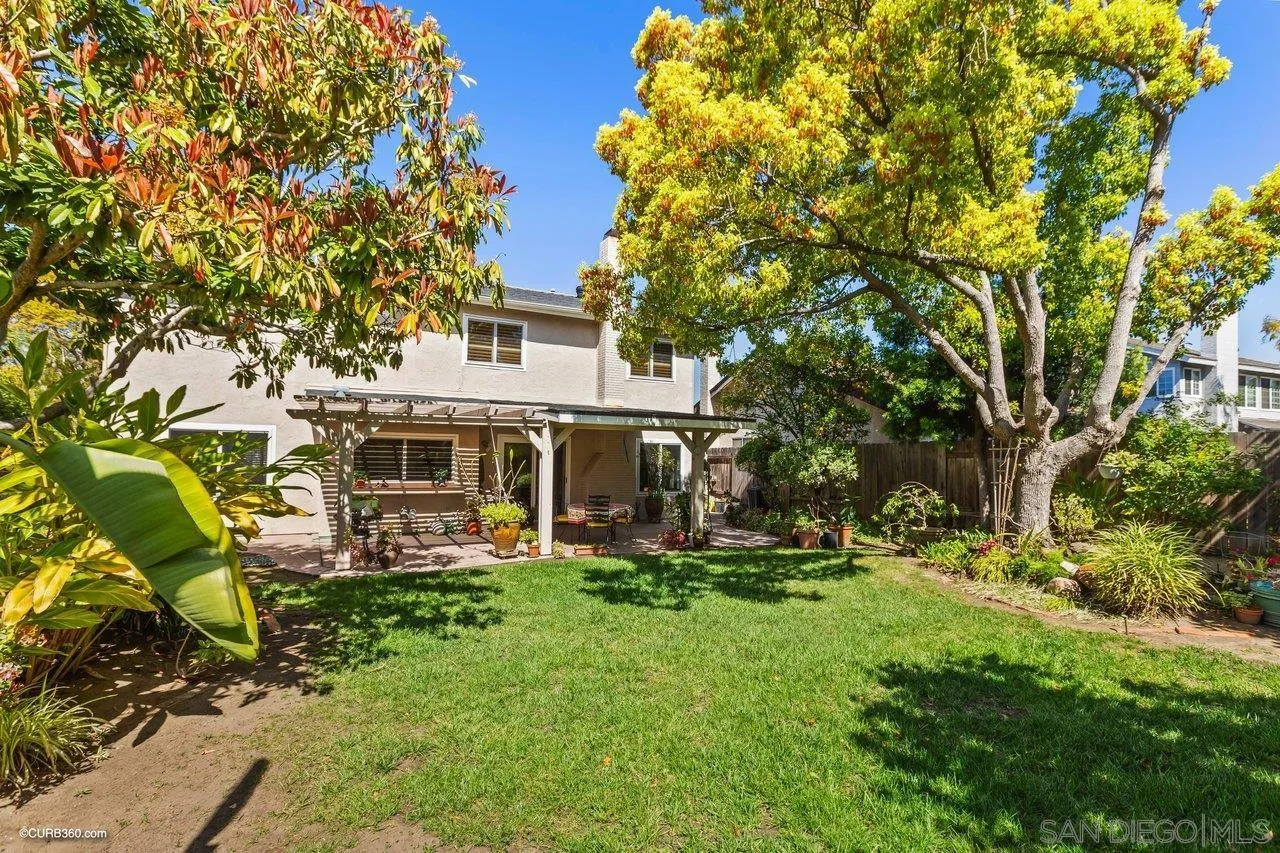 744 Roca Road Chula Vista, CA 91910 - Photo 23 of 24 a front view of a house with a big yard and large trees