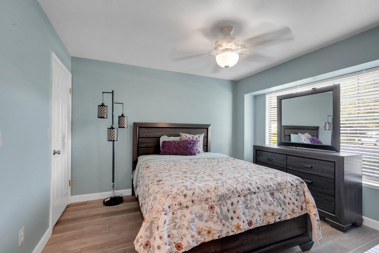 2809 Fleming Court Modesto, CA 95356 - Photo 15 of 34 a bedroom with a large bed and a chandelier