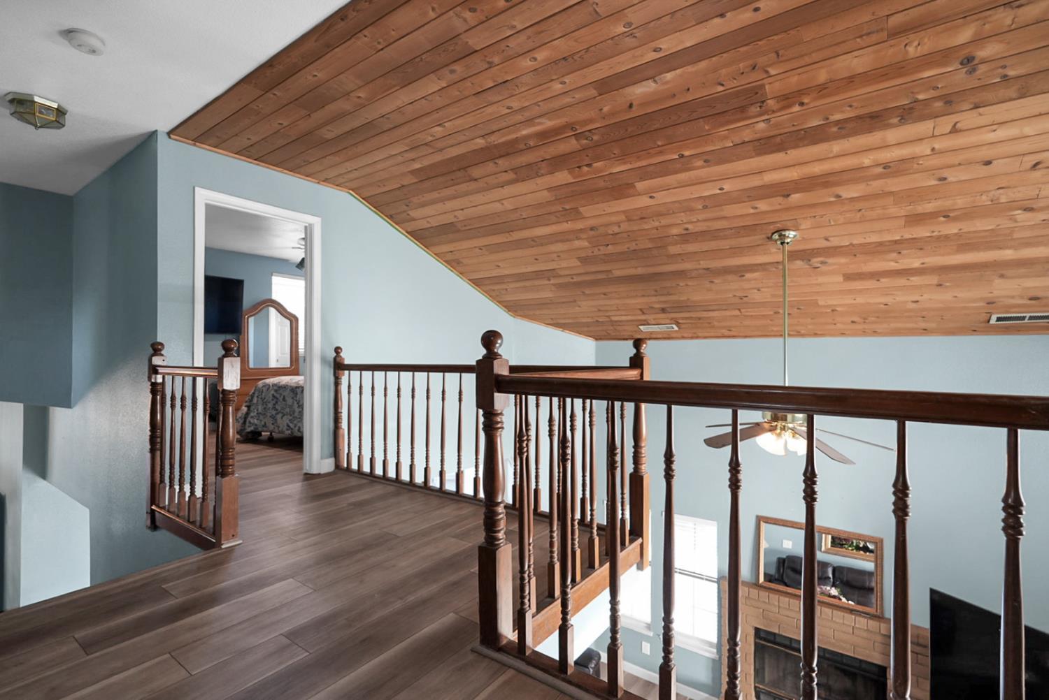 2809 Fleming Court Modesto, CA 95356 - Photo 16 of 34 a view of a hallway with wooden floor and stairs