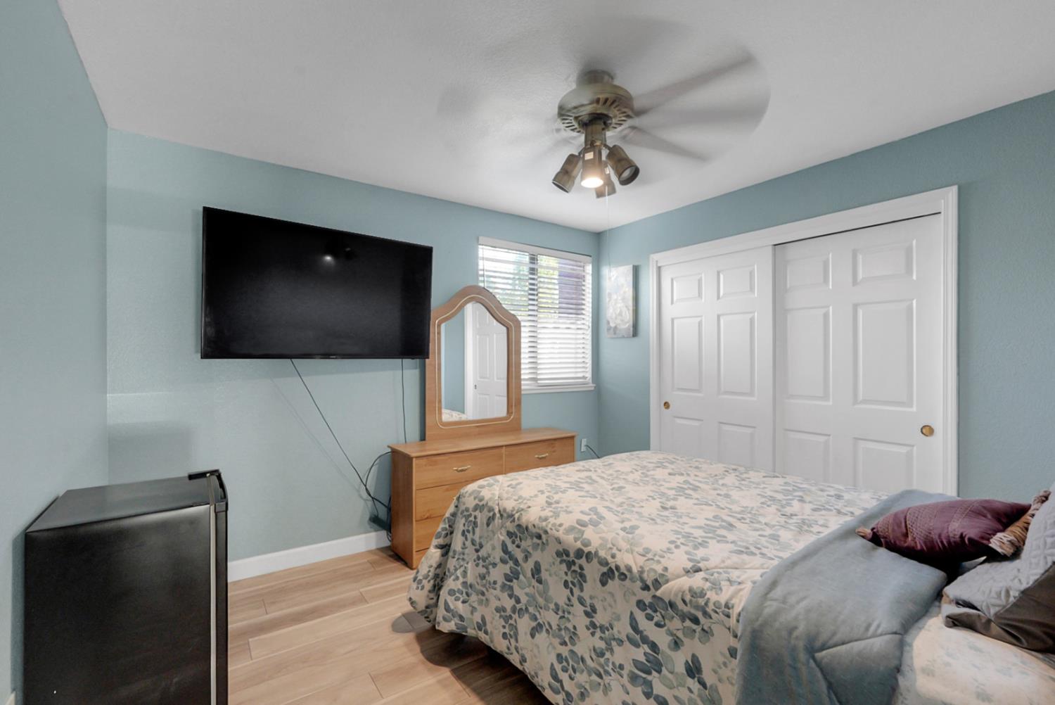 2809 Fleming Court Modesto, CA 95356 - Photo 19 of 34 a bedroom with a bed and a flat screen tv