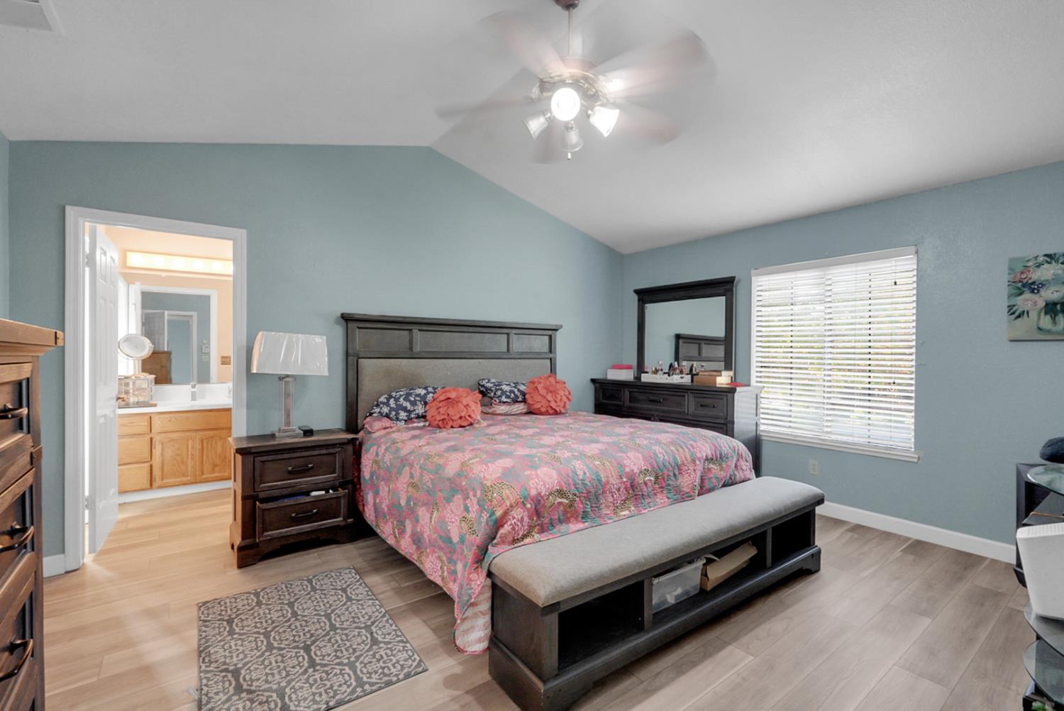 2809 Fleming Court Modesto, CA 95356 - Photo 21 of 34 a bedroom with a bed and a chandelier