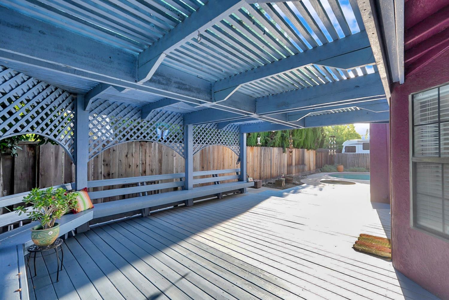 2809 Fleming Court Modesto, CA 95356 - Photo 25 of 34 a view of a backyard with a table and chairs under an umbrella with wooden floor