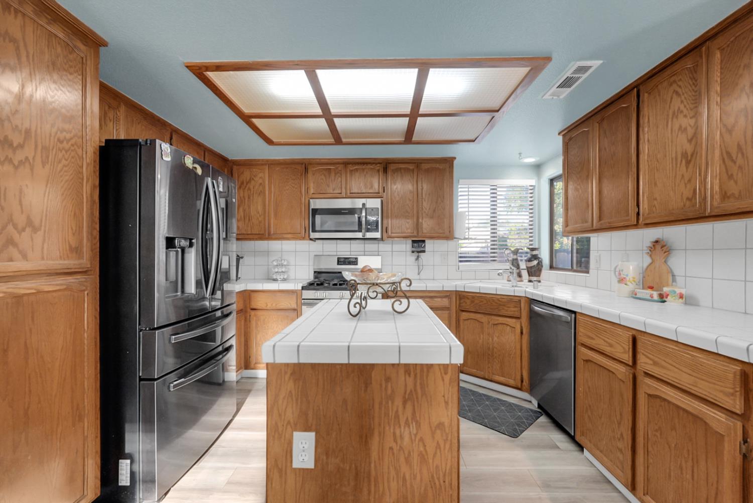2809 Fleming Court Modesto, CA 95356 - Photo 8 of 34 a kitchen with granite countertop a refrigerator stove top oven a sink and dishwasher