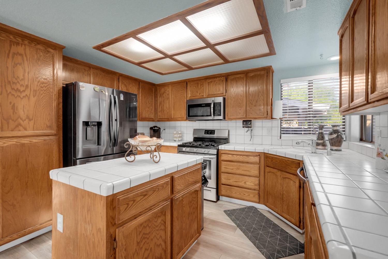 2809 Fleming Court Modesto, CA 95356 - Photo 9 of 34 a kitchen with stainless steel appliances a refrigerator sink stove microwave and cabinets