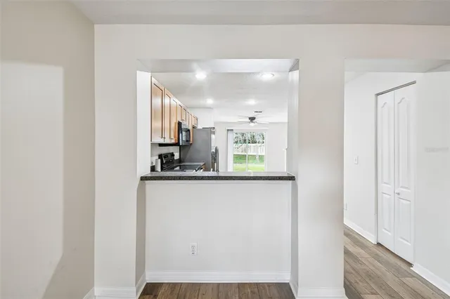 a kitchen with stainless steel appliances a refrigerator and a window