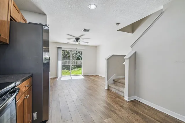 a view of livingroom with hardwood floor and a ceiling fan