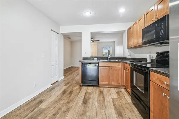 a kitchen with granite countertop stainless steel appliances and wooden cabinets