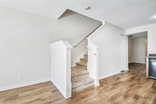 a view of entryway and hall with wooden floor