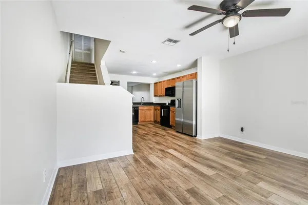 a view of a kitchen with a sink and a refrigerator