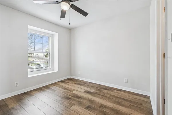 an empty room with fan and a ceiling fan