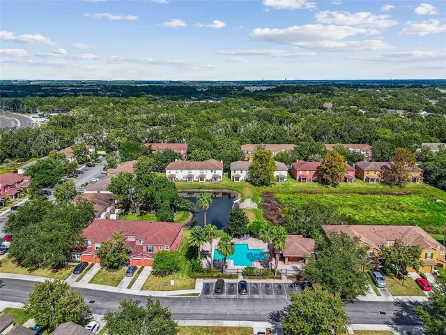 an aerial view of a house with a yard basket ball court and outdoor seating