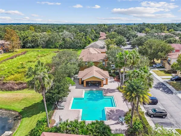 a view of backyard with swimming pool and seating space