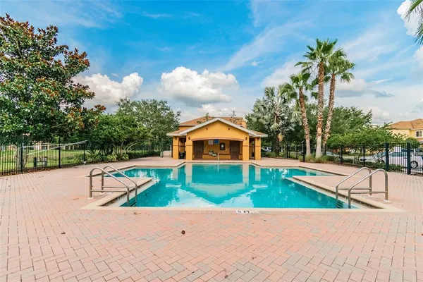 a view of an house with swimming pool and porch