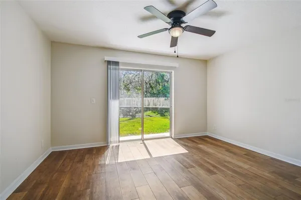 wooden floor in an empty room with a window