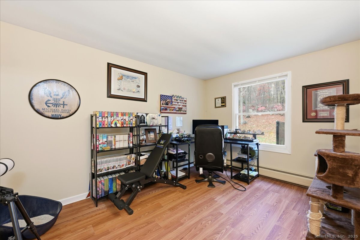 198 Dartmouth Drive Groton, CT 06355 - Photo 12 of 25 a view of a workspace with lounge chair and a window