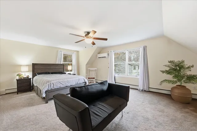 a spacious bedroom with a bed and a couch