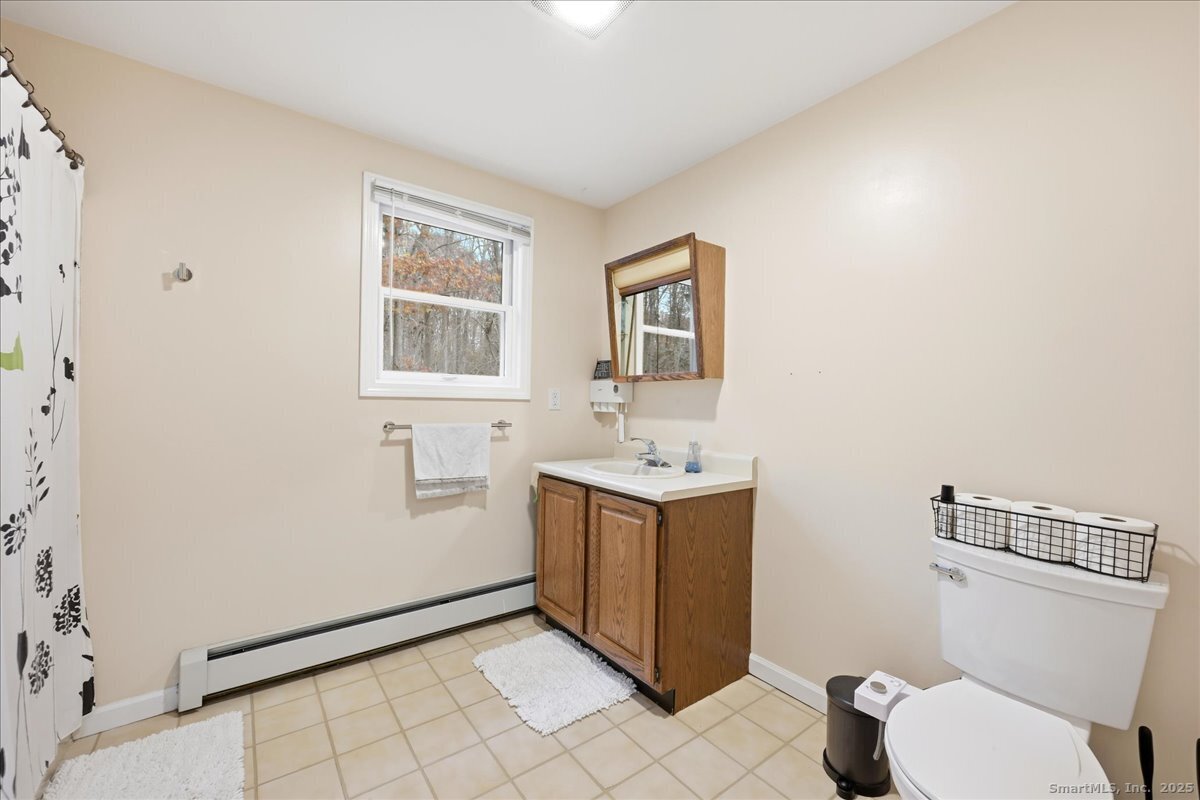 198 Dartmouth Drive Groton, CT 06355 - Photo 19 of 25 a bathroom with a toilet sink and mirror