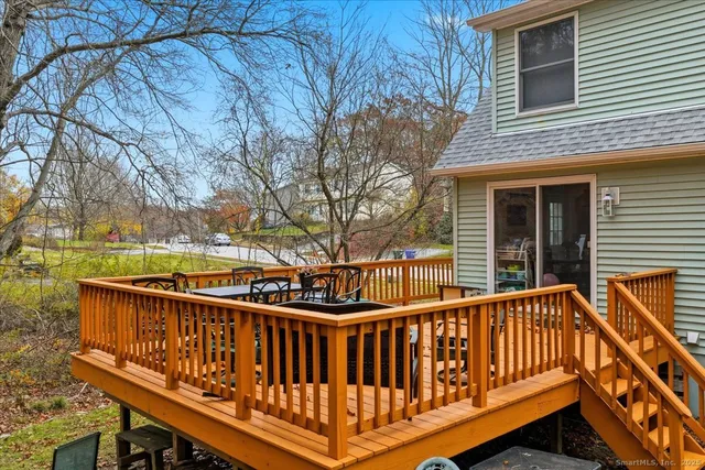 a view of a roof deck with wooden fence and wooden floor