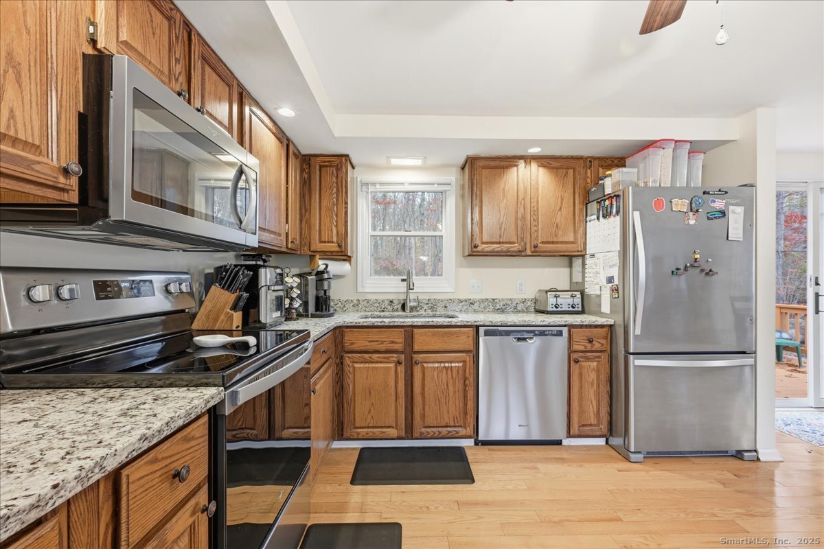 198 Dartmouth Drive Groton, CT 06355 - Photo 8 of 25 a kitchen with stainless steel appliances granite countertop a refrigerator and a sink