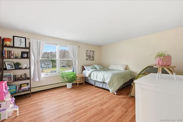 a spacious bedroom with a bed and a window
