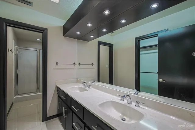 a bathroom with a double vanity sink and a mirror