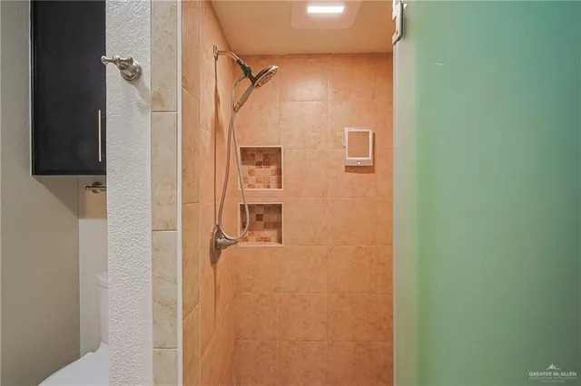 a bathroom with a shower and a mirror