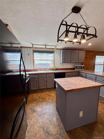 a kitchen with stainless steel appliances granite countertop a stove and a sink