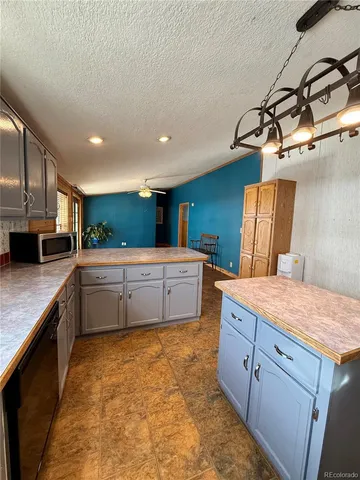 a kitchen with stainless steel appliances a sink and a refrigerator