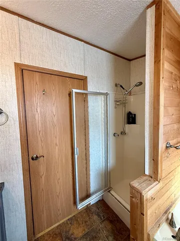 a bathroom with a shower and a sink
