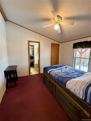 a bed sitting in a bedroom next to a window